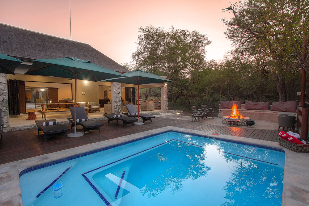Outside Pool area lapa with a fire burning next to the Kruger National Park Outside Pool area lapa with a fire burning next to the Kruger National Park