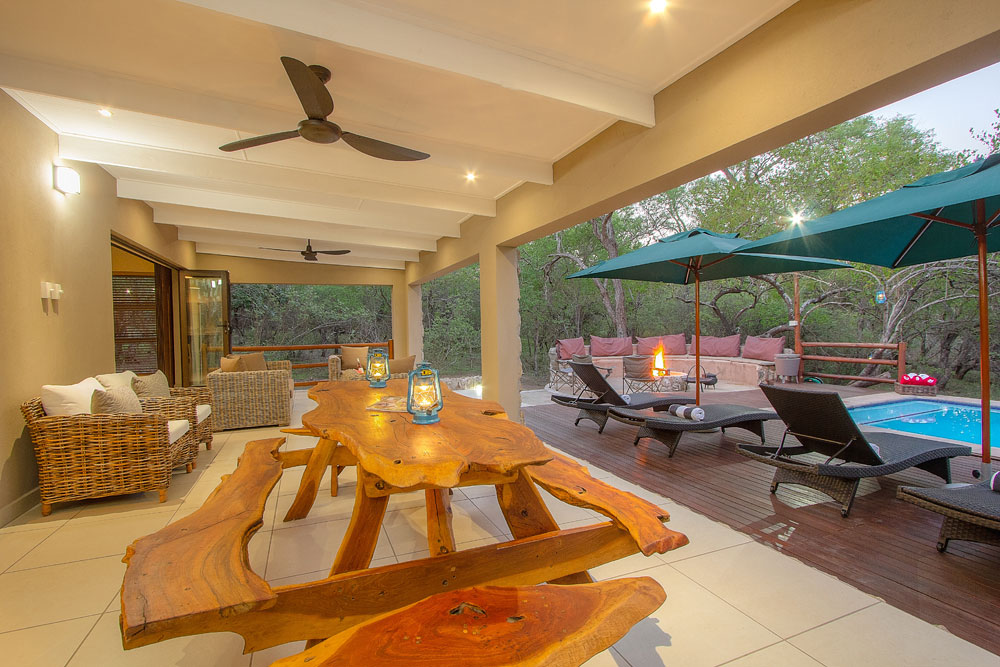 Relaxed seating area Inside Bush Lodge area lapa with a fire burning next to the Kruger National Park Relaxed seating area Inside Bush Lodge area lapa with a fire burning next to the Kruger National Park