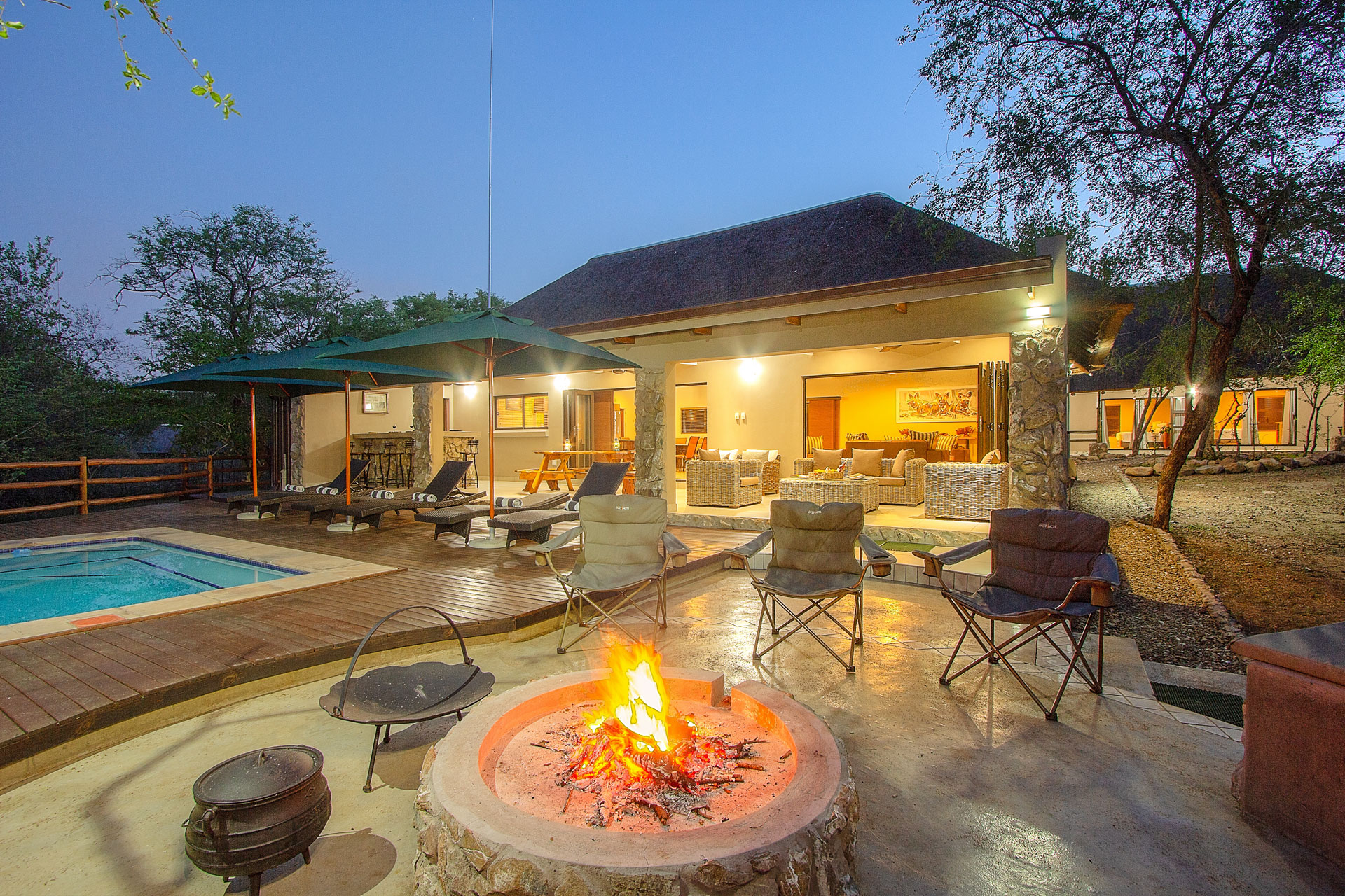 Outside Pool area lapa with a fire burning next to the Kruger National Park Outside Pool area lapa with a fire burning next to the Kruger National Park